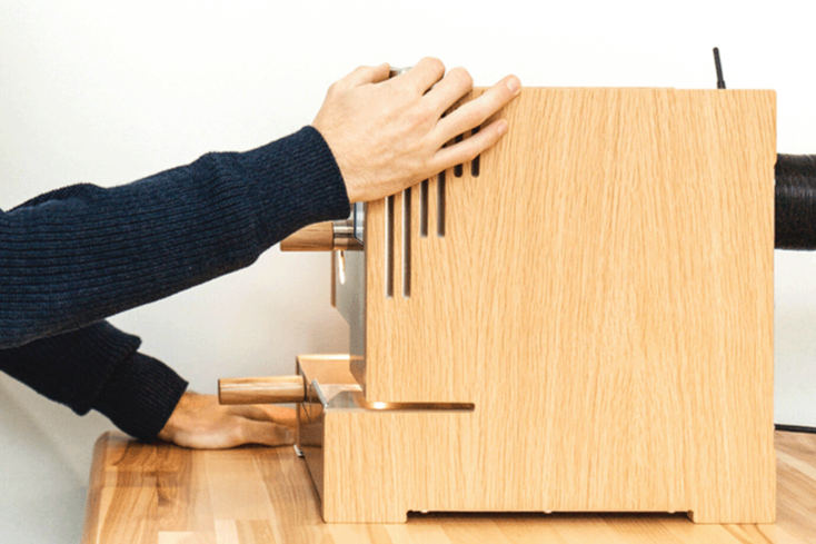 quality control manager adjusting setting on roest sample roaster s200 in wood design