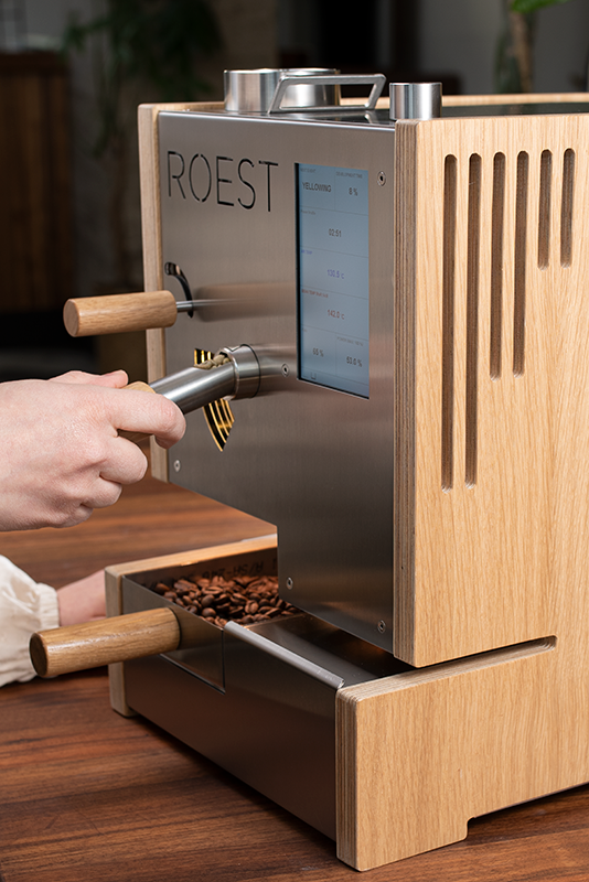 ROEST S200 in wood finish operated by a roasting manager checking quality with a bean trier